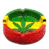 Handcrafted round-shaped flat incense holder ash tray with Rasta-colored mosaic tile design and cannabis pot leaf in green, yellow, and red color combination.