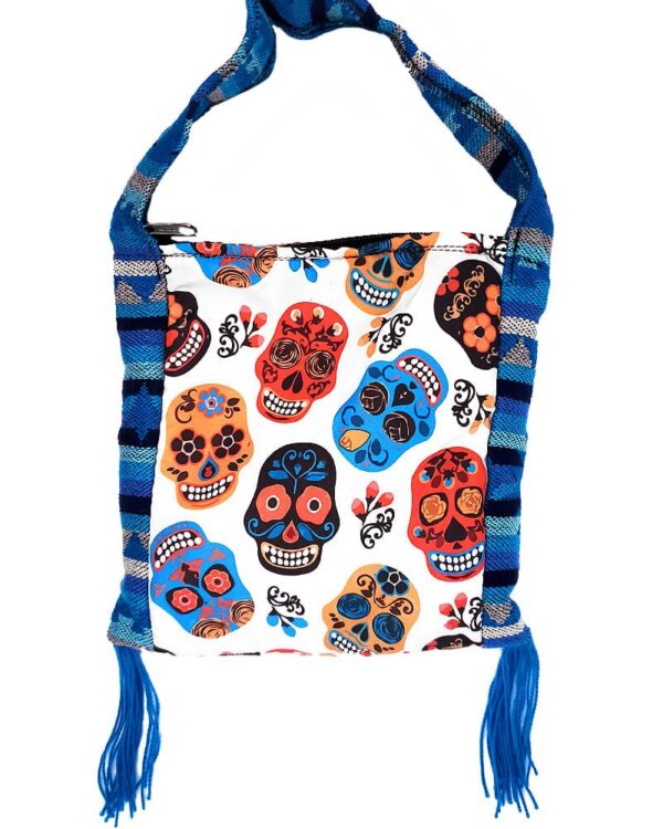 Handmade small square-shaped padded crossbody purse bag with woven tribal print striped pattern, multicolored floral Day of the Dead sugar skull design, and fringe in white, red, turquoise blue, golden yellow, and black color combination.