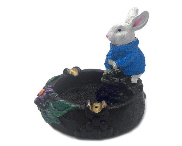 Handcrafted round incense holder ash tray with a flower and leaf design and 3D figurine of a rabbit holding money in turquoise, green, black, and gold color combination.