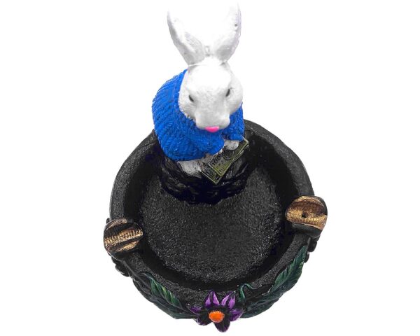 Handcrafted round incense holder ash tray with a flower and leaf design and 3D figurine of a rabbit holding money in turquoise, green, black, and gold color combination.